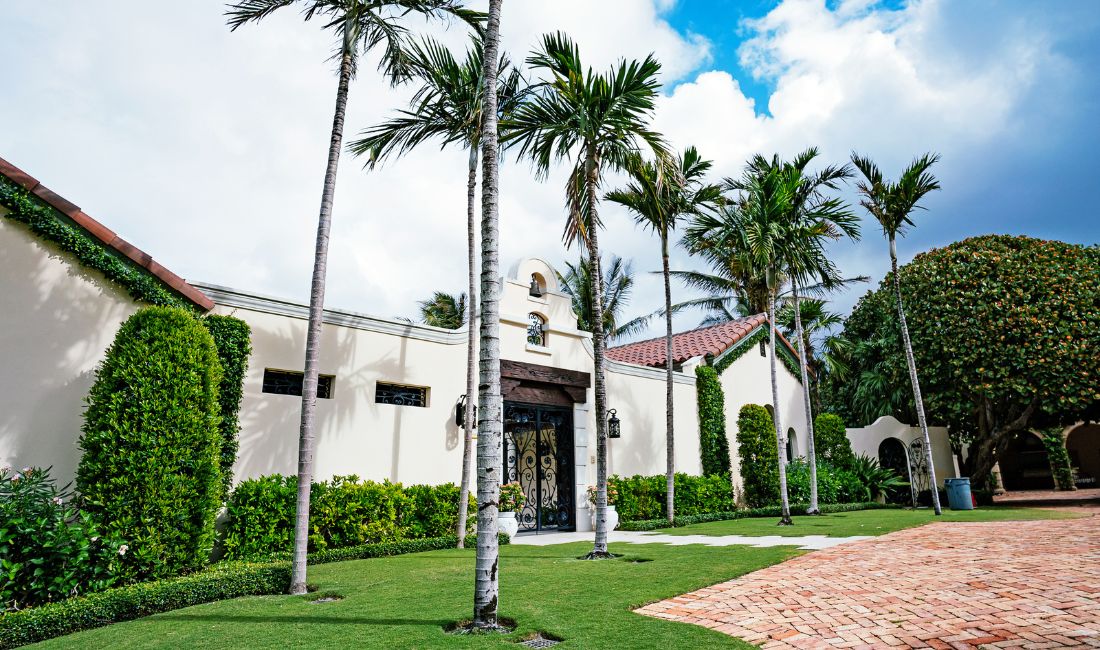 A Palm Beach property maintained by Coastal Gardens with a healthy, green lawn.